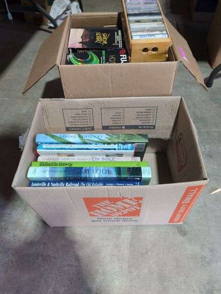 Boxes of Media and Books: Cassettes, VHS Tapes, DVDs, and Assorted Books
