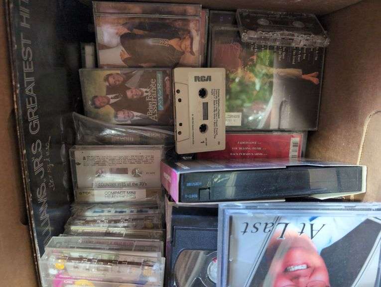 Boxes of Media and Books: Cassettes, VHS Tapes, DVDs, and Assorted Books