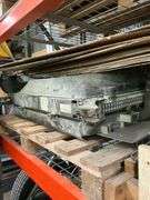 Shelf of Various Items - Coolant Reservoir, Hydraulic Fluid, Wheeled Machine