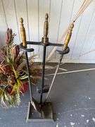 Fireplace Screen with Tools, Decorative Floral Arrangements, and Ironing Board