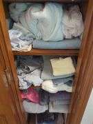 contents of Linen Cabinet with Linens and towels