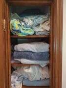 contents of Linen Cabinet with Linens and towels