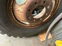 Truck Tire, Metal Tool Box with Contents, and Assorted Parts