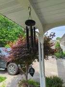 Assorted Outdoor Decor Items: Bench, Milk Can, Wind Chimes, and More