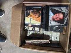 Boxes of Media and Books: Cassettes, VHS Tapes, DVDs, and Assorted Books