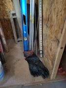 Building and Construction Tool Lot: Empire Level, Conduit, Measuring Stick, and More