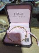 Kirk Pewter Necklace, 1973 Canadian Dollar Display, and Juicy Couture Bracelet