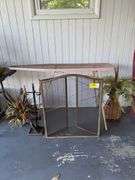 Fireplace Screen with Tools, Decorative Floral Arrangements, and Ironing Board