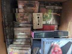 Boxes of Media and Books: Cassettes, VHS Tapes, DVDs, and Assorted Books