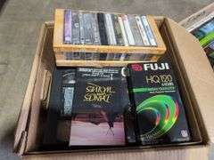 Boxes of Media and Books: Cassettes, VHS Tapes, DVDs, and Assorted Books