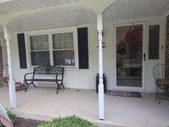 Assorted Outdoor Decor Items: Bench, Milk Can, Wind Chimes, and More