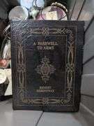 Mixed Collection: Brass Fireplace Cover, Books, and Decorative Items