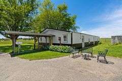 AUCTION! TWO HOMES • FINISHED METAL BUILDING (BARNDOMINIUM) • 70'x40' BARN • 9± ACRES